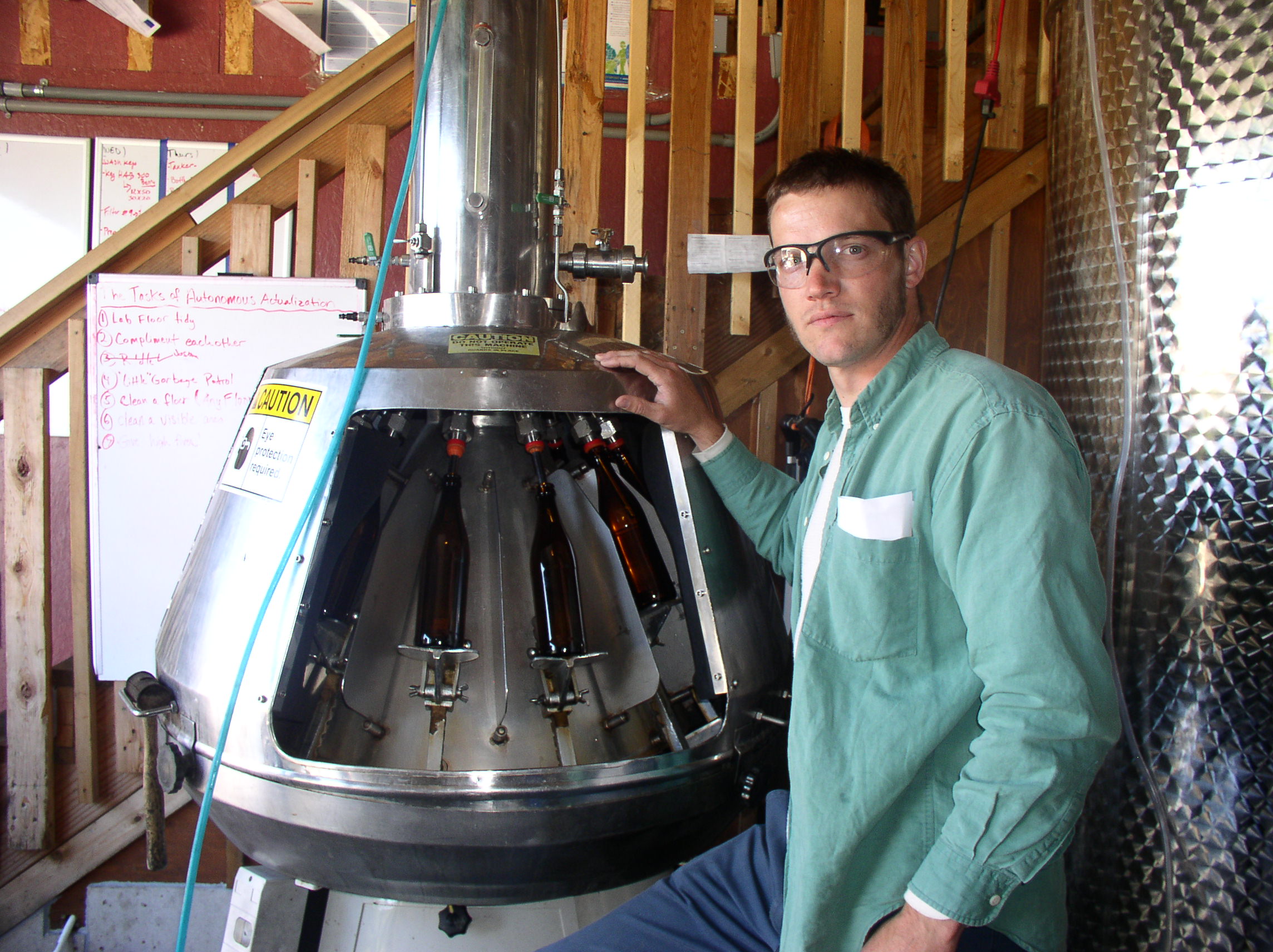 Finnriver's production manager, Andrew Byers, at the facility's bottling machine